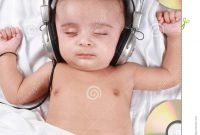 2 month old baby listening to music stock photo - image of indian