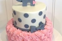 baby shower cake with elephant on top the cake is a pink rosette