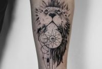 by koit, berlin. forearm black tattoo - lion, compass and illuminati