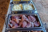 country buffet for a wedding reception under an open barn. chicken