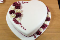 heart shaped wedding cake with whimsical flowers - fondant covered