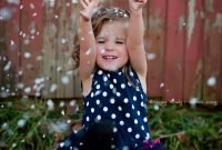 kids outdoor christmas session fake snow, old sled, and barn